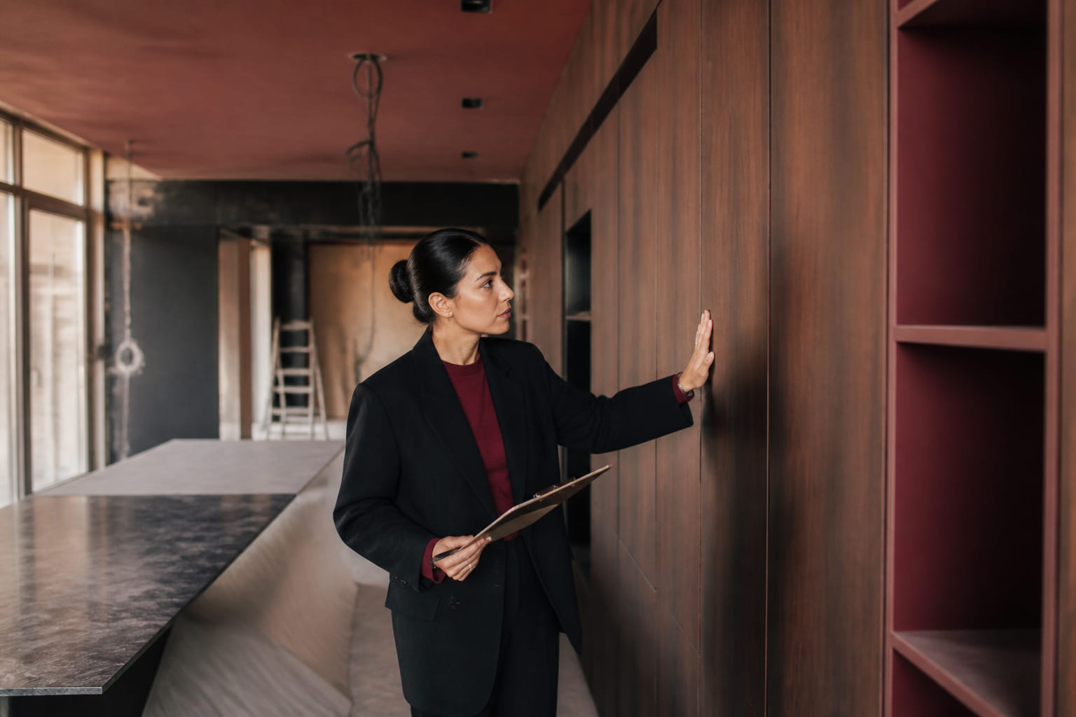 Interior designer inspecting joinery quality on site